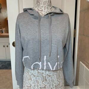 Calvin Klein Cropped Hoodie. Heather Grey w/white lettering approx. size M